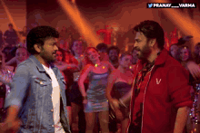 two men are dancing in front of a crowd and the words pranay varma are on the bottom