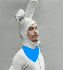 a man wearing a white sweater and bunny ears