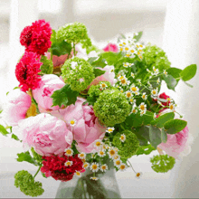 a vase filled with pink and green flowers