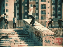 a skateboarder is doing a trick on a ramp with graffiti on it including one that says " fuck "
