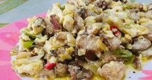 a close up of a plate of food with meat , eggs and vegetables on a table .