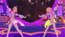 two anime girls are dancing on a stage in front of a heart shaped display .