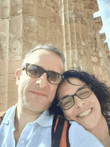 a man and a woman wearing sunglasses are posing for a photo