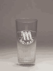 a clear glass with the word ro-kap etched on it