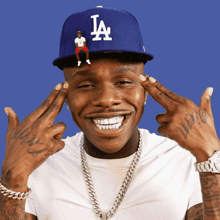 a man wearing a la hat is making a funny face