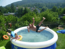 a man is falling into an inflatable swimming pool that says smart set