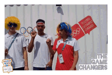 a group of people are posing for a photo in front of a sign that says " youth olympic games "