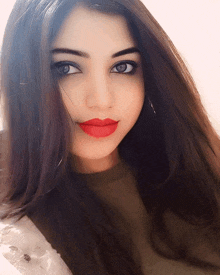 a close up of a woman 's face with long hair and red lipstick