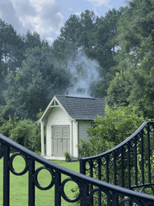 a shed with smoke coming out of the roof