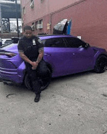 a police officer is standing next to a purple car .