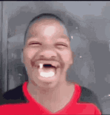 a young boy with a missing tooth is making a funny face with his mouth open .