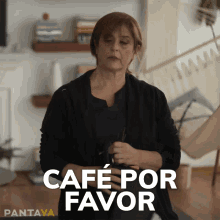 a woman in a black sweater is holding a cup of coffee and says " cafe por favor "