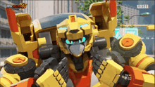 a yellow robot with blue eyes is on a screen that says ebs11