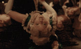 a woman in a green and white dress is dancing