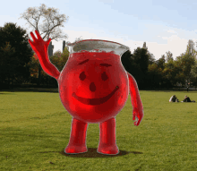 a pitcher of red liquid with a smiling face on it