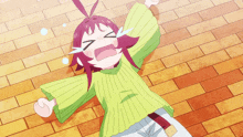 a girl with red hair and a green sweater is crying on the floor