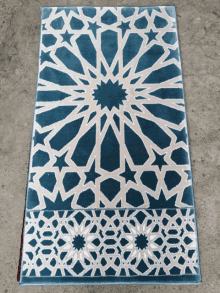 a blue and white rug with a star pattern on it