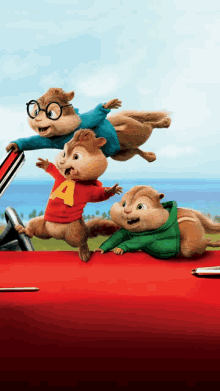 three cartoon chipmunks with one wearing a red shirt that says a