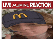 a picture of a child wearing a mcdonald 's hat with a m on it