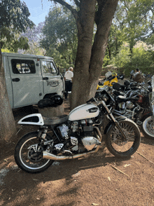 a triumph motorcycle is parked next to a jeep