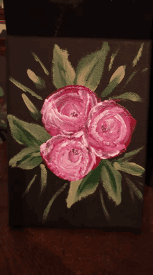 a painting of three pink roses with green leaves on a black background