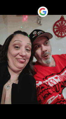 a man and a woman are posing for a picture with a google sticker in the background