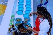 a woman in an apron is preparing food in front of a table with bowls and bottles and the letters pdtv6 on the top