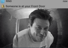 a black and white photo of a man with a ring notification that someone is at your front door