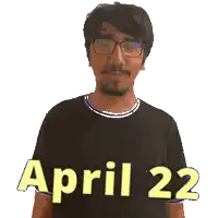 a man wearing glasses and a black shirt with the date april 22