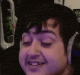 a close up of a person wearing headphones and making a face .