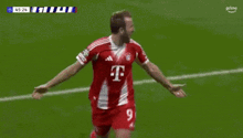 a man in a red and white t-mobile jersey celebrates