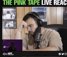 a man wearing headphones is sitting in front of a microphone with the words the pink tape live react written above him