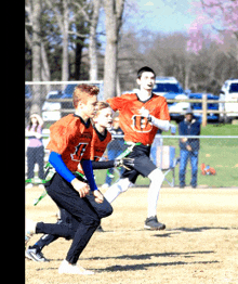 a group of young boys are playing a game of flag football and one of their shirts says u.s. army