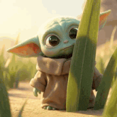 a baby yoda is standing next to a tall grass leaf in the desert .