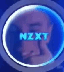 a man 's face is behind a blue circle that says nzxt on it .