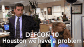 a man in a suit and tie talking to a woman in an office with the words defcon 10