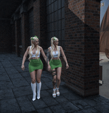 two women wearing green skirts and white socks are walking in front of a brick wall