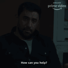 a man with a beard asks how can you help in front of an amazon prime video sign