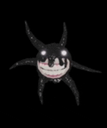 a cartoon character with horns and a smile on its face is floating in the dark .