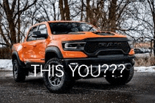 a ram truck is parked on the side of a road in the snow .