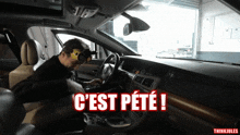 a man wearing a mask is sitting in a car with the words c'est pete in red