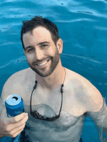 a man in a pool holds a can of bud light