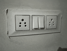 three electrical switches and two electrical sockets on a wall that says ' jvc ' on the bottom