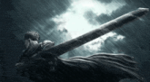 a man holding a sword in the rain