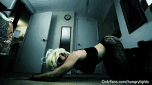 a woman laying on the floor with the website onlyfans.com/hungrylights visible