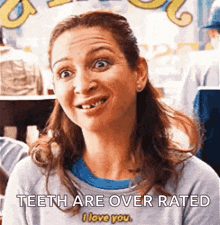 a woman with missing teeth is smiling and saying teeth are over rated .
