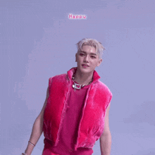 a man wearing a pink vest and a necklace with the word happy above him