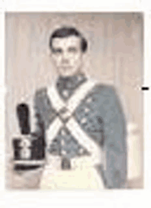 a blurry picture of a man in a military uniform holding a bottle .