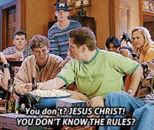 a group of people sitting around a table with one man saying " you do n't jesus christ "