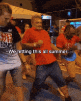 a man in a red shirt is dancing with the words we hitting this all summer